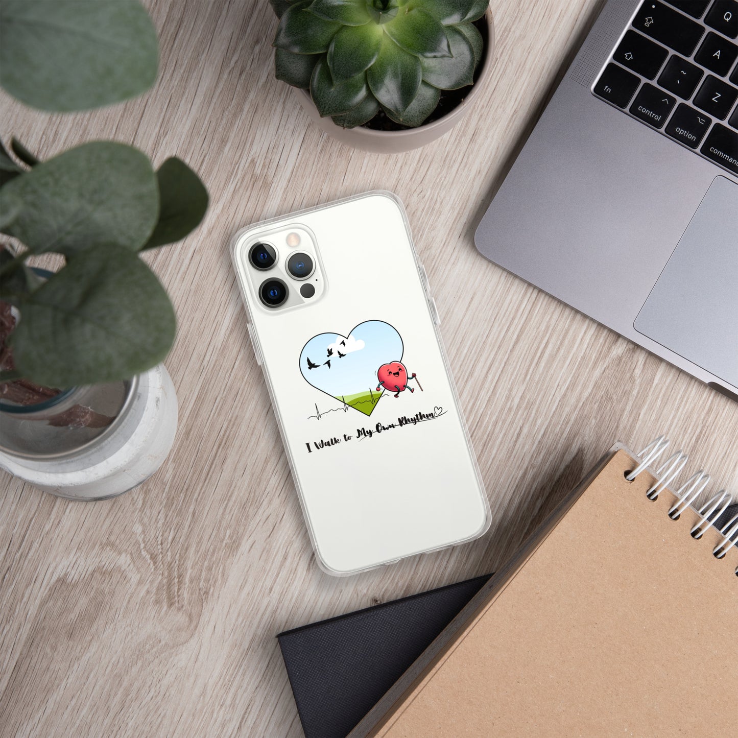 a phone case sitting on top of a desk next to a laptop