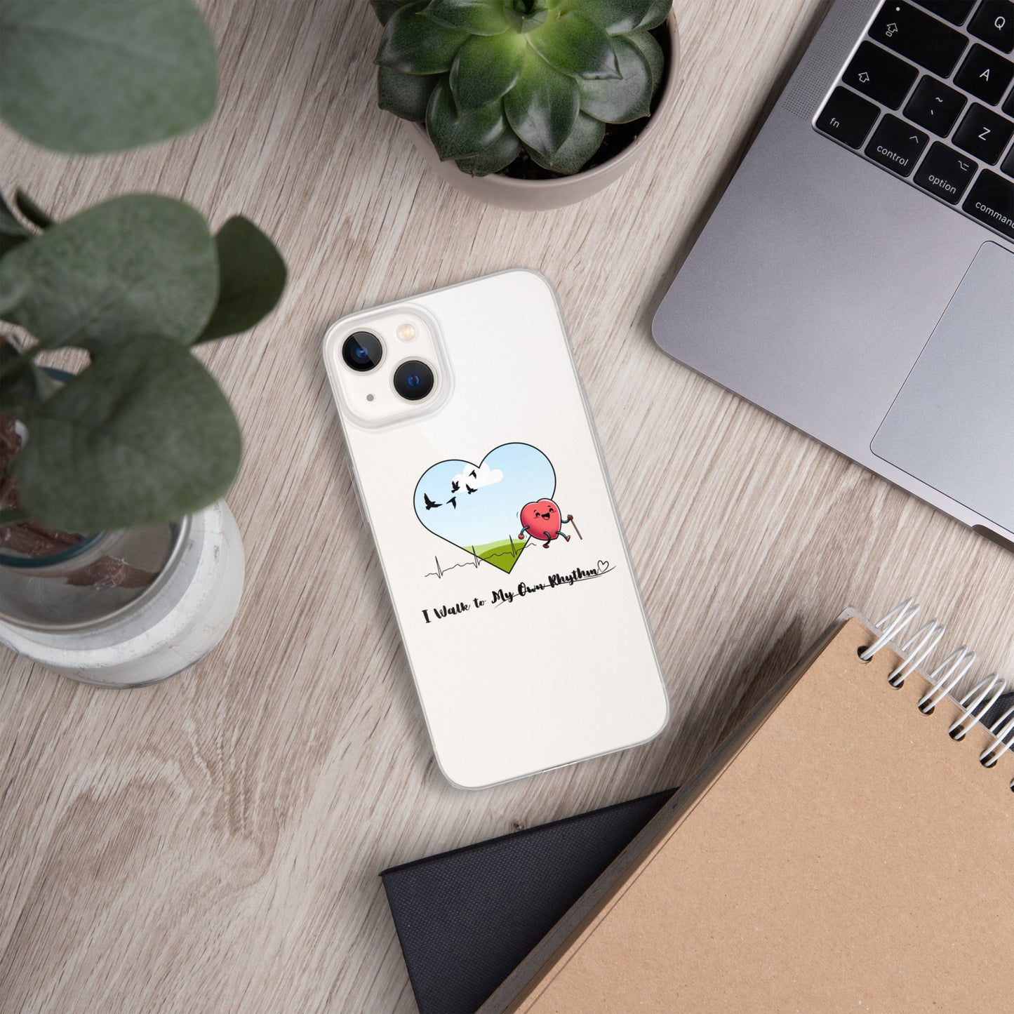 a phone case sitting on top of a desk next to a laptop